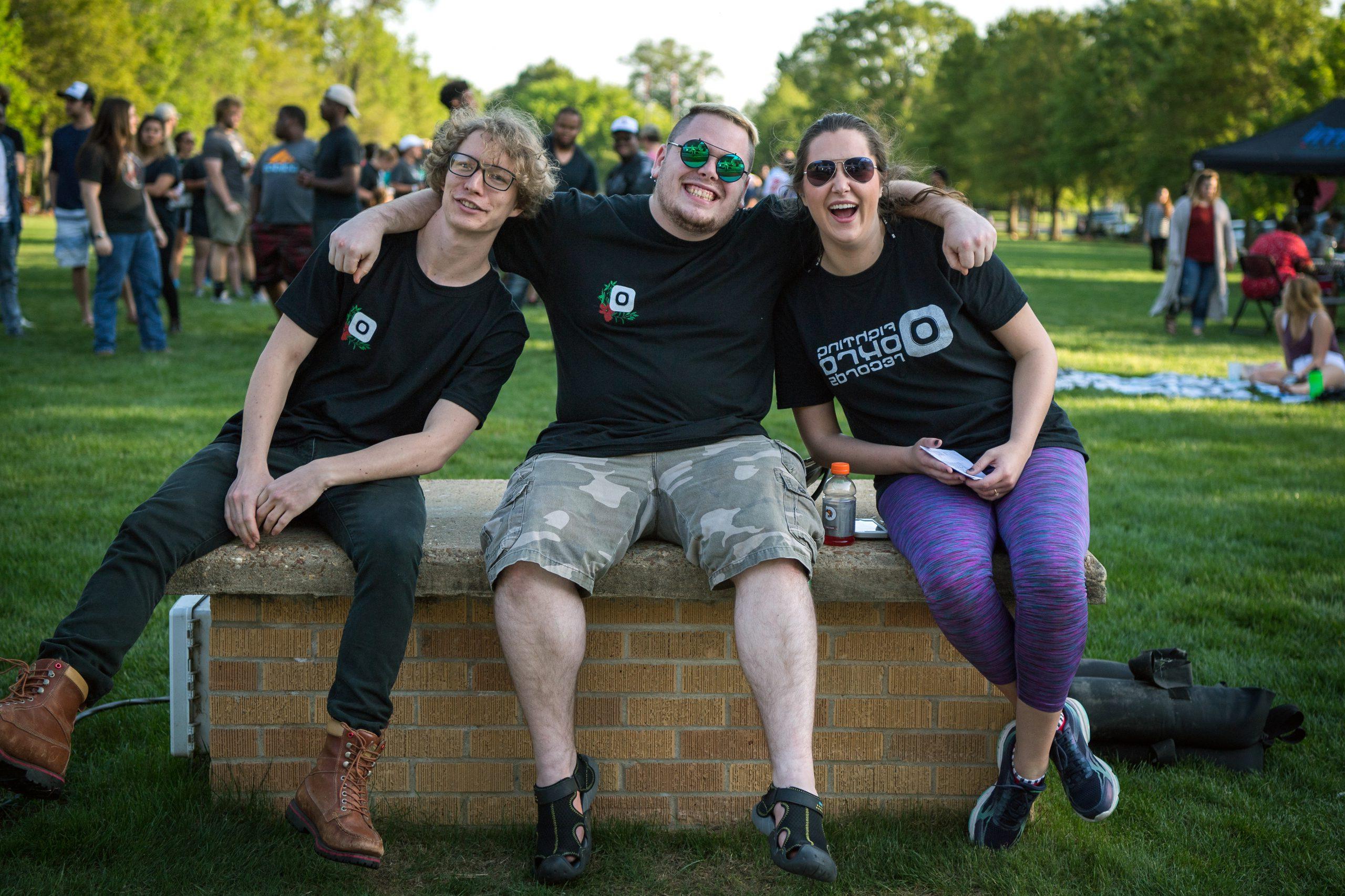 3 students at fighting okra records event on the Quad.